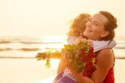 A mother getting a gift from her kid on st augustine beach