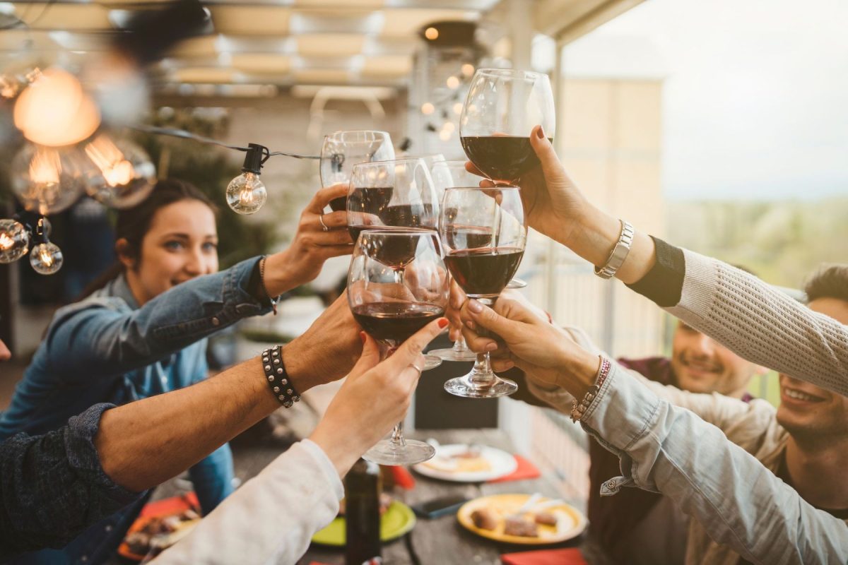 friends on patio toasting wine glasses
